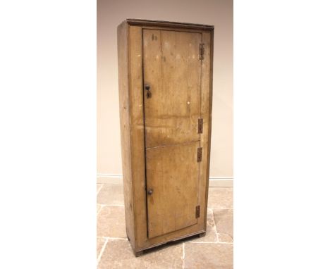 A 19th century free standing pine kitchen cupboard, the twin doors opening to four fixed shelves, upon block feet, 201cm H x 