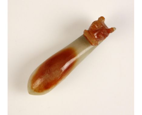 A Chinese carved jade belthook, Qing dynasty, of ruyi sceptre form and carved with a beasts mask, with russet hues, 7cm longC