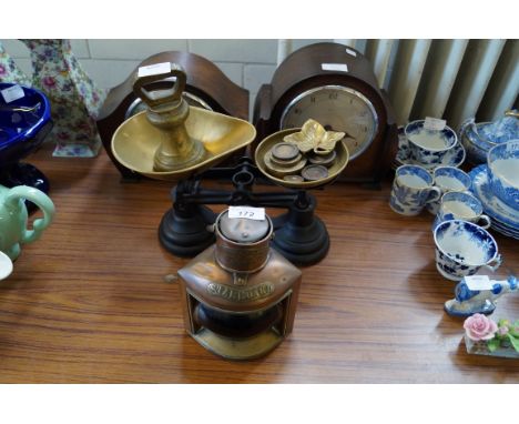 A mixed lot of assorted items to include a pair of balance scales, two oak mantel clocks, and copper starboard lamp.