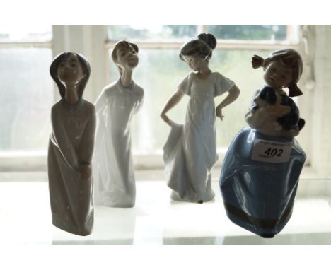 A group of four Nao and Lladro figures to include two Lladro examples of a boy and girl, a Nao girl holding a dog and a furth