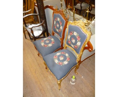A pair of early 20th Century French Louis XVI revival salon chairs, one in gilt finish and one in the wood finish, both with 
