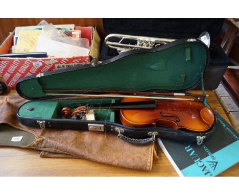 A vintage stained violin with bow and travelling case.