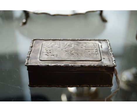 An Edwardian silver vesta case of rectangular form, the lid embossed depicting a scene of two figures on a bench, with applie