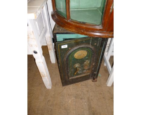 A vintage cast metal safe with label T Withers & Son Wolverhampton, complete with key