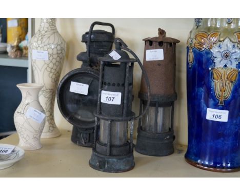 Two vintage miners lamps together with a further car lamp.