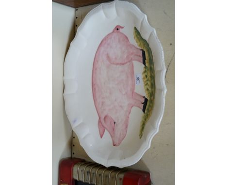 A vintage Italian pottery meat plate decorated with a pig.