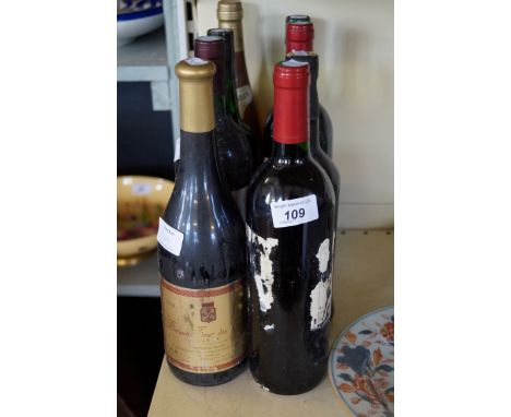 Eight bottles of assorted wine and spirits.
