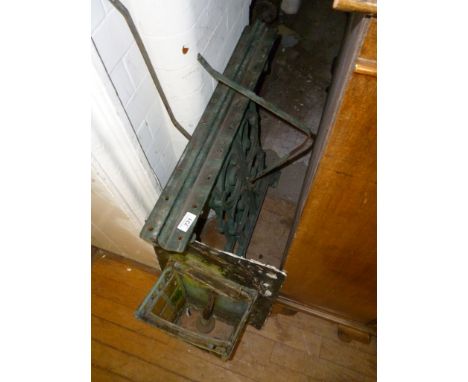 A pair of vintage cast metal table bases together with a wall light.