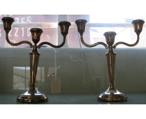 A silver pair of three light, two branch candelabra, Birmingham 1973, loaded
