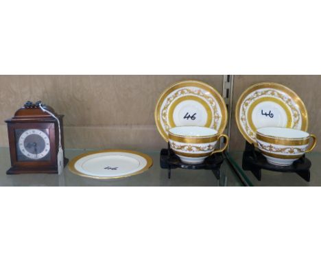 A pair of Mintons gilded cups and saucers together with a single plate and a mantle clock, 13cm high 