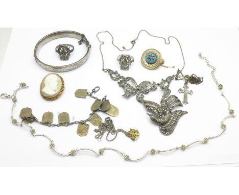 A silver bangle, two silver lockets and four brooches