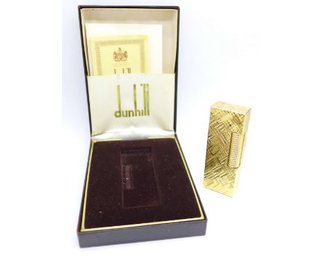 A Dunhill lighter with original guarantee and instructions, boxed