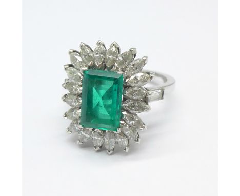 A platinum set, emerald and diamond cluster ring, purchased in 1964 in Rome, Fürst Jewellers, in original box and with copy o