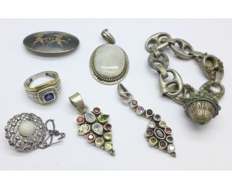 Two multi-stone pendants marked .925, a silver ring, a silver niello brooch, a .925 silver and white stone pendant, an .800 s