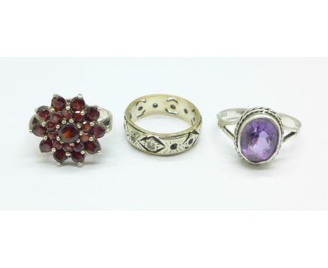 Three rings, silver and garnet, silver and amethyst and 9ct gold and silver