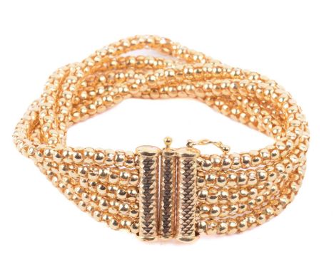 A popcorn link bracelet in 9ct yellow gold, comprising five rows of popcorn links, fastened with a faceted slide clasp and fi