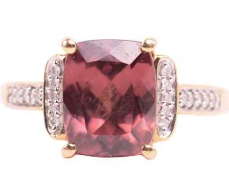 A red zircon and diamond dress ring in 18ct yellow gold, centred with a cushion-cut red zircon in a claw setting, flanked by 