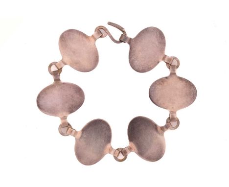 Georg Jensen - a silver bracelet with six oval disc links, with round flat loops connecting the panels, fastened with an S-ho