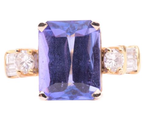 A tanzanite and diamond dress ring, centred with octagonal-cut tanzanite with strong pleochroism, claw-set between shoulders 