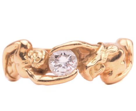 A French figural ring set with diamond, stylised as a man and woman hugging a brilliant-cut diamond, with an estimated weight