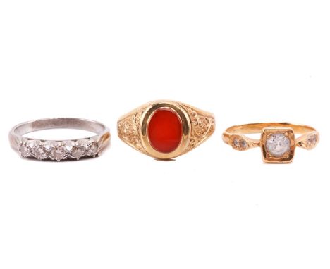 Three gem-set rings; including a carnelian signet ring in 9ct yellow gold, with an oval head and engraved scrollwork on shoul