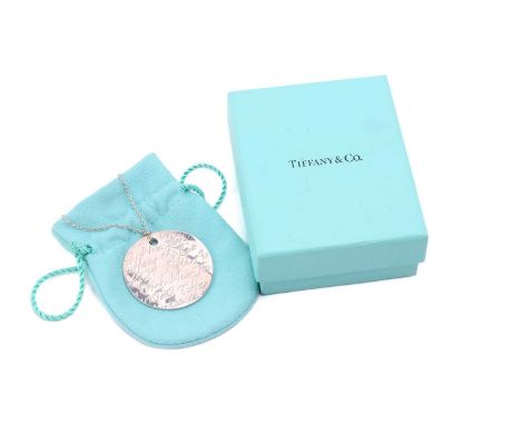 Tiffany &amp; Co. - a silver 'New York Notes' pendant on chain, the curved circular pendant engraved with the brand's New Yor
