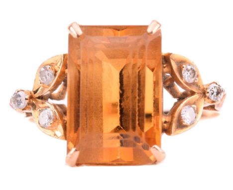 A citrine and diamond dress ring, containing a canted rectangular step-cut citrine, approximately measures 13.5 x 9.2 x 10.4 