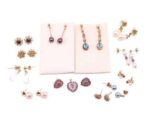 Twelve pairs of earrings and a ruby set pendant. The first pair of stud earrings comprise a heart shape set with rubies on ye
