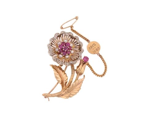 A gem-set flower spray brooch in 9ct gold, the wirework flowerhead edged with diamond accents, centred with a cluster of face