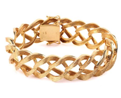 A mid-century 9ct gold link bracelet; composed of bark finish, angular figure of eight links, to a concealed push-button clas
