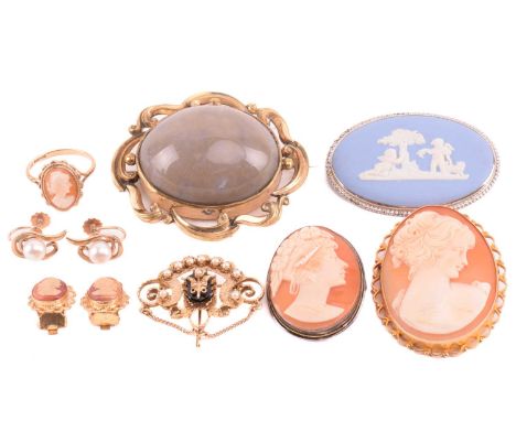 An onyx and seed pearl brooch with a scrolling foliate design, marked 14k to the reverse, an oval shell cameo brooch with a f