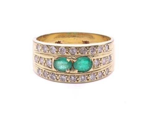 An emerald and diamond ring set with two oval-cut emeralds between rows of round brilliant cut diamonds, with a total diamond