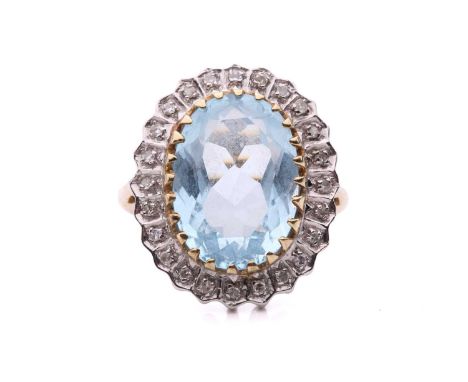 A topaz and diamond cluster ring in 9ct gold, the light blue topaz measuring 3.8 x 9.7 mm, encircled by single cut diamonds i
