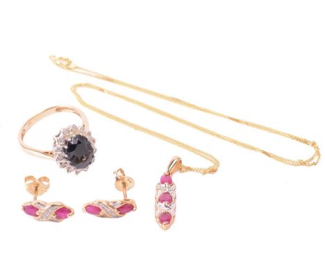 A ruby necklace and earrings ensuite together with a dress ring; the pendant set with three oval-cut flux-healed rubies flank