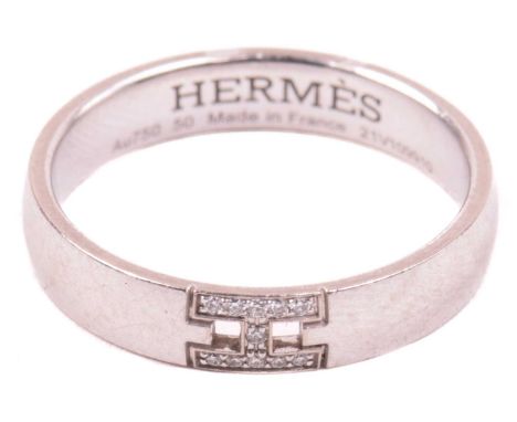 Hermès - an 'Ever Herakles' wedding band set with diamonds, composed of a court-profile band, embellished with an 'H' motif s