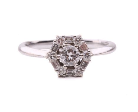 A diamond cluster ring, set with a central round brilliant cut diamond with an estimated weight of 0.30ct, within a hexagonal