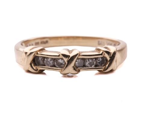 A channel-set diamond ring in 14ct yellow gold, comprising three cross-lashing motifs, flanked by rows of brilliant-cut diamo