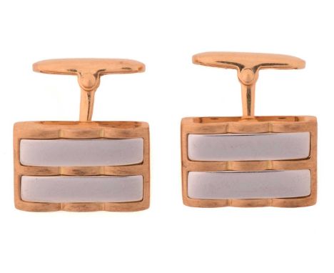A pair of geometrical cufflinks, each comprising a rectangular reeded panel with two stripes of inlaid, fitted with swivel to