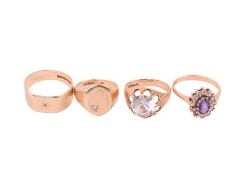 Four rings, all in 9ct gold, including an amethyst and paste cluster ring, ring size R, a solitaire ring set with paste, ring