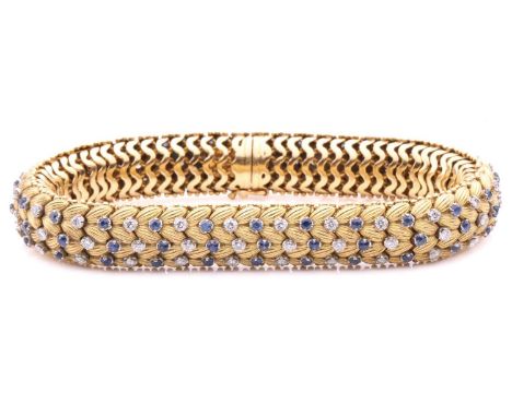 Illario - a diamond and sapphire snake link bracelet, circa 1960, the articulated links of foliate design embellished with a 