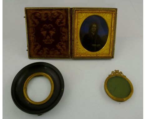 A 19TH CENTURY CASED DAGUERROTYPE PHOTOGRAPH depicting a portrait of a lady, hand tinted and gilded, case 9cm x 8cm, together