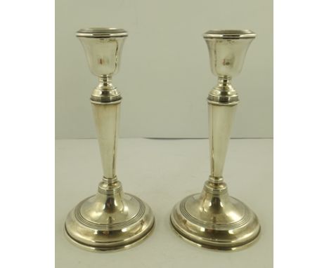 WILLIAM HUTTON AND SONS LTD A PAIR OF EARLY 20TH CENTURY SILVER CANDLESTICKS of Georgian design, on circular bases, Birmingha