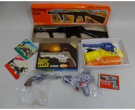 A COLLECTION OF TOY GUNS including; Tudor Rose Tommy Gun boxed, Crescent Rustler boxed and two carded Colt/Webley Tudor Rose 