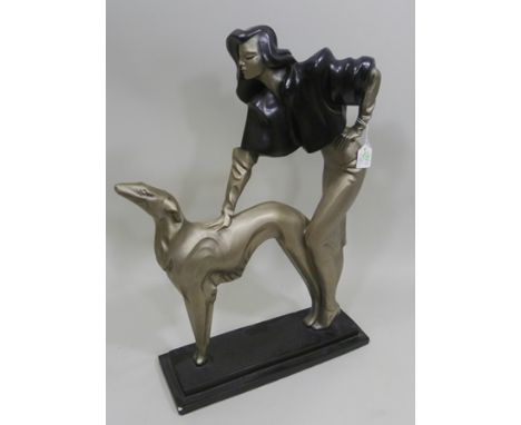 AN ART DECO STYLE FIGURE OF A STYLISH LADY AND GREYHOUND painted in silver, 70cm high by R Danel for Austin Products 1989