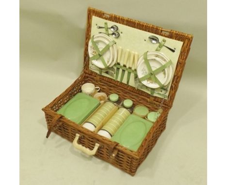 A BREXTON WICKER PICNIC HAMPER with contents; flasks, cutlery, china plates etc. 
