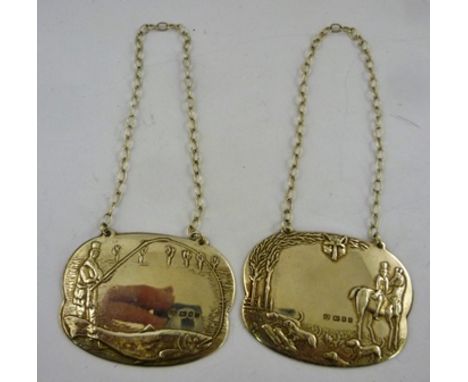 A PAIR OF LATE 20TH CENTURY SILVER SPIRIT LABELS, one decorated with a fox hunting scene, the other a Victorian fisherman, Lo