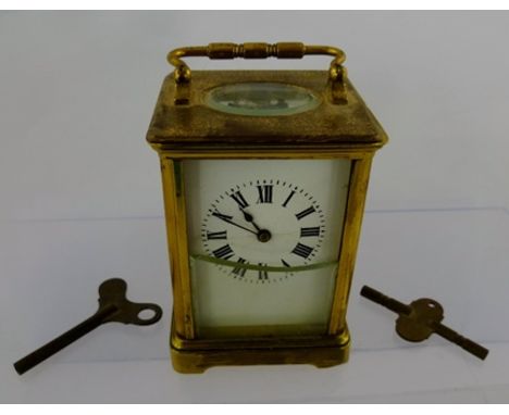 A LATE 19TH CENTURY BRASS CASED CARRIAGE CLOCK, fitted hinged bale handle, the white enamel dial with Roman numerals, 11cm hi