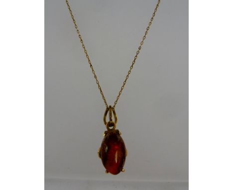 A POLISHED CABOCHON OPAL mounted in pendant frame stamped 14k, suspended on a 9ct gold chain 