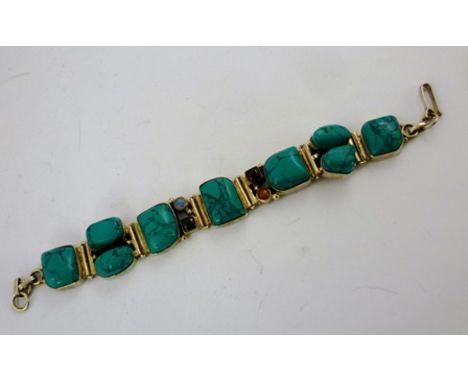 A SILVER BANGLE inset turquoise and various other cabochon stones, 15cm 