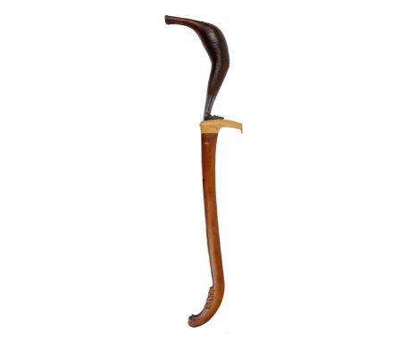 λ A Sumatran knife (rentjong), slender single edged re-curved blade 9.5 in., faceted socket; the horn hilt of characteristic 